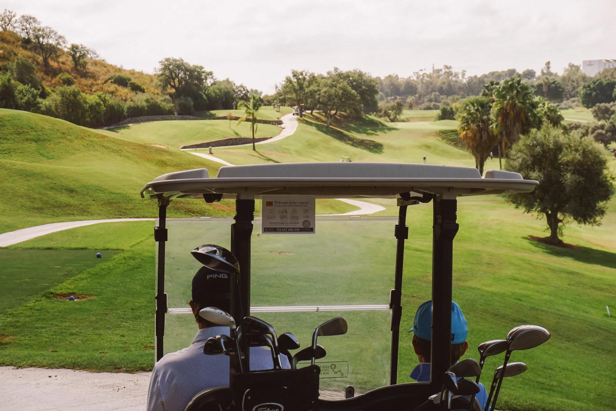 Two players in golf buggy