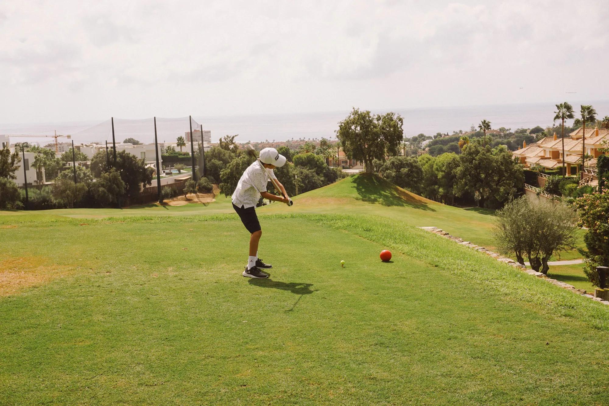 Junior player teeing off